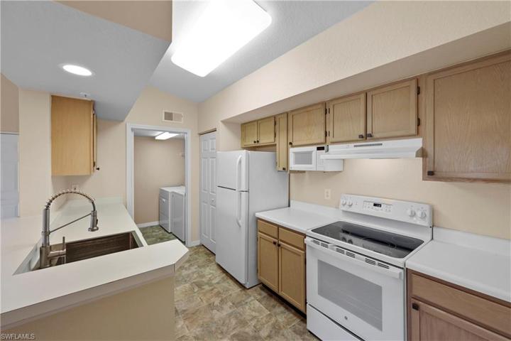 Large open kitchen with separate laundry room
