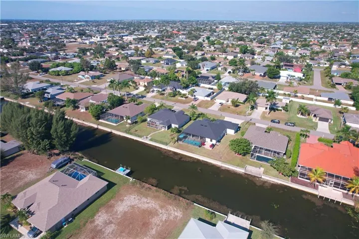 Aerial overview of property's location with nearby suburban area and a large body of water