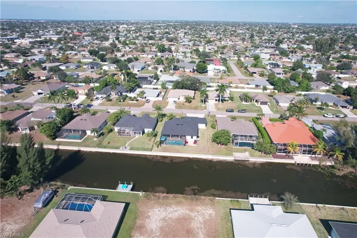 Aerial view of property's location with nearby suburban area and a large body of water