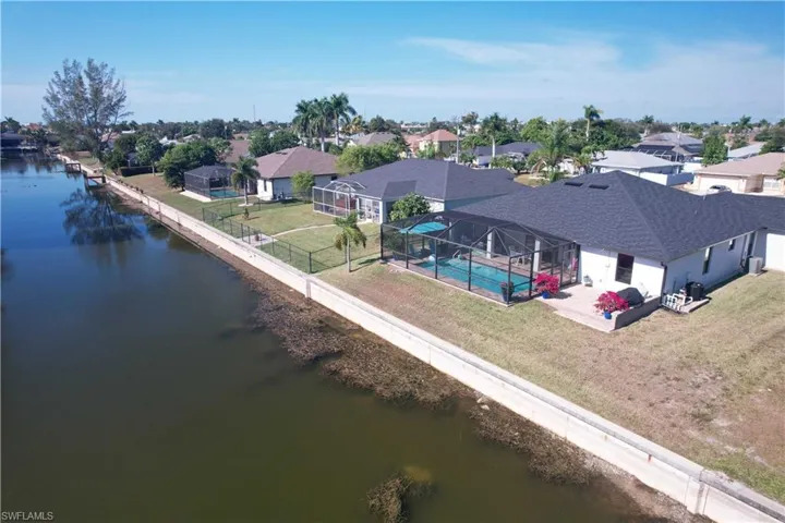 Aerial perspective of suburban area featuring a nearby body of water