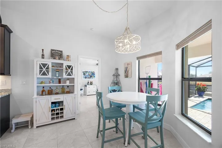 Dining area featuring light tile patterned flooring and a ceiling fan