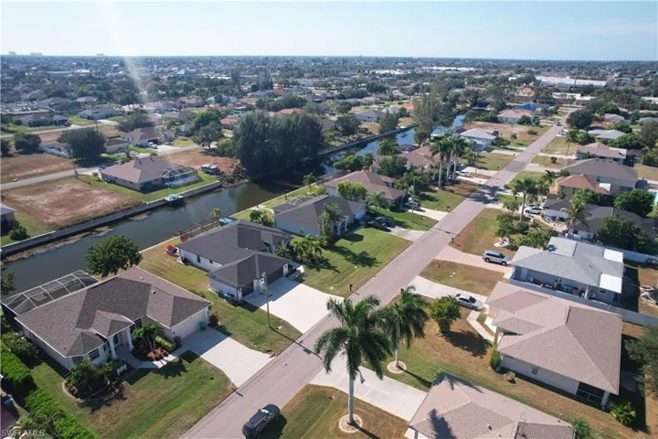 Aerial overview of property's location featuring nearby suburban area and a nearby body of water