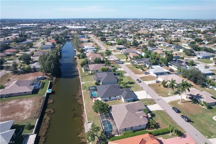 Aerial perspective of suburban area with a large body of water