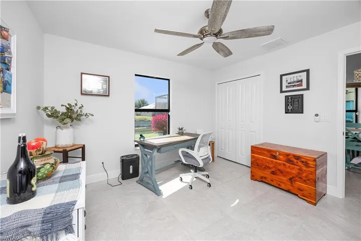 Home office featuring a ceiling fan and baseboards