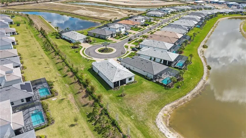 Aerial perspective of suburban area featuring a large body of water