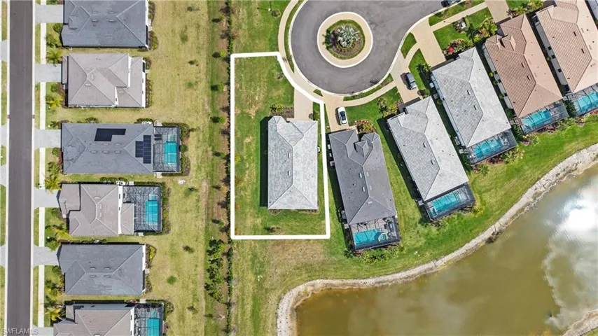 Aerial perspective of suburban area with a nearby body of water
