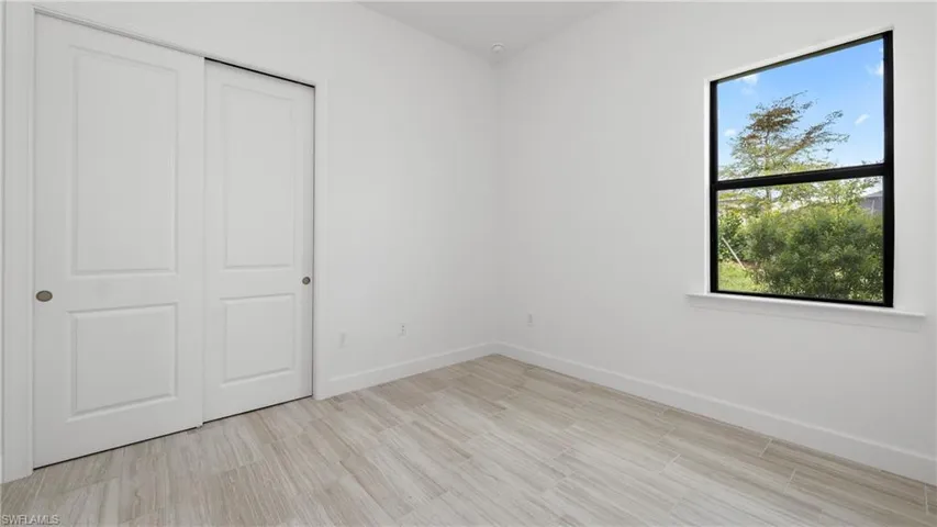 3rd bedroom featuring a closet and tile floors
