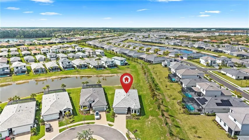 Aerial perspective of suburban area featuring a large body of water