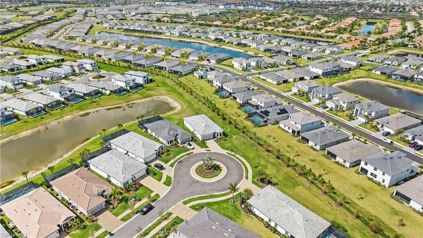Aerial view of property's location featuring nearby suburban area and a large body of water