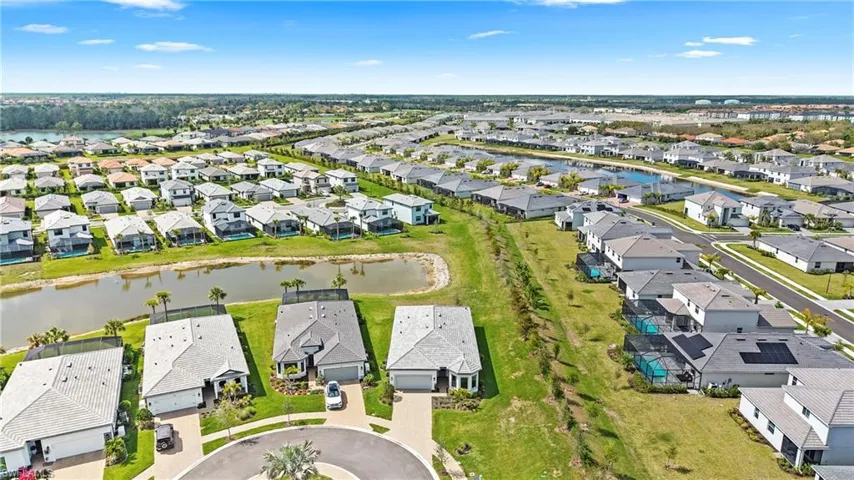 Aerial perspective of suburban area featuring a large body of water