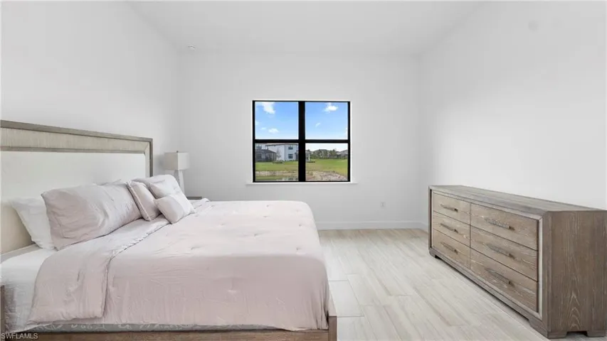 Bedroom with wood finish floors and baseboards