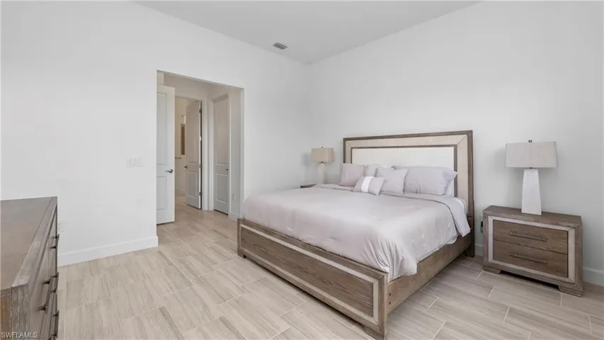Bedroom featuring baseboards and wood finish floors