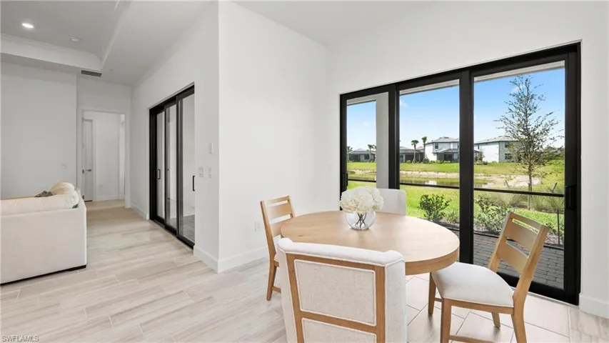 Dining room featuring wood tiled floors, ornamental molding, recessed lighting, and a residential view