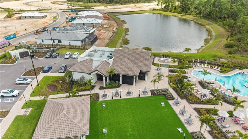 Drone / aerial view of a large body of water and a pool