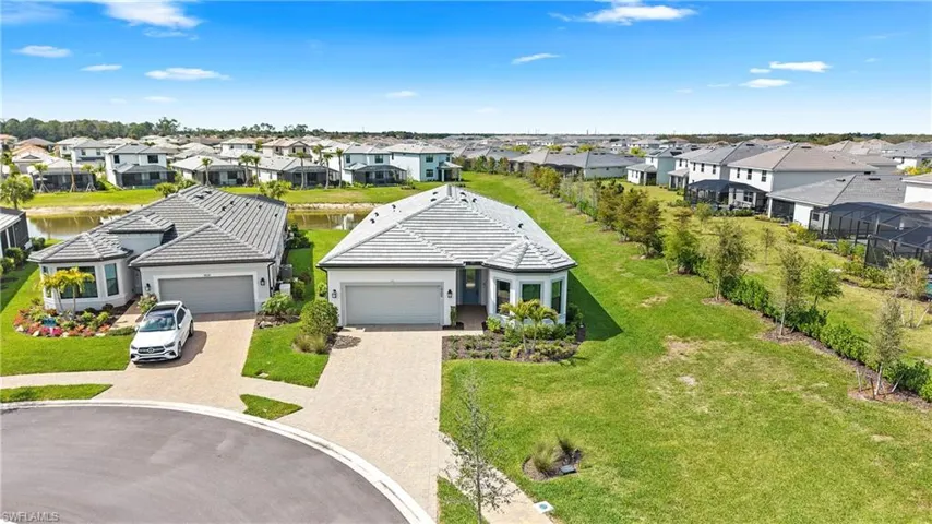 Aerial perspective of suburban area featuring a nearby body of water