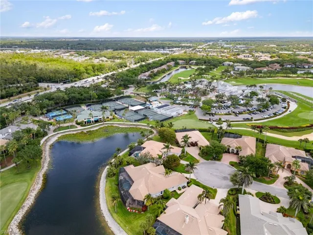 Birds eye view of property featuring golf course view, a water view, and a residential view