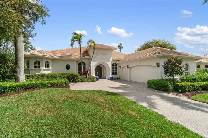 Mediterranean / spanish-style home featuring decorative driveway, a tile roof, stucco siding, and a garage