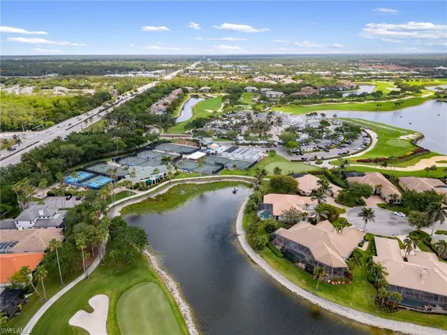Drone / aerial view featuring view of golf course, a residential view, and a water view
