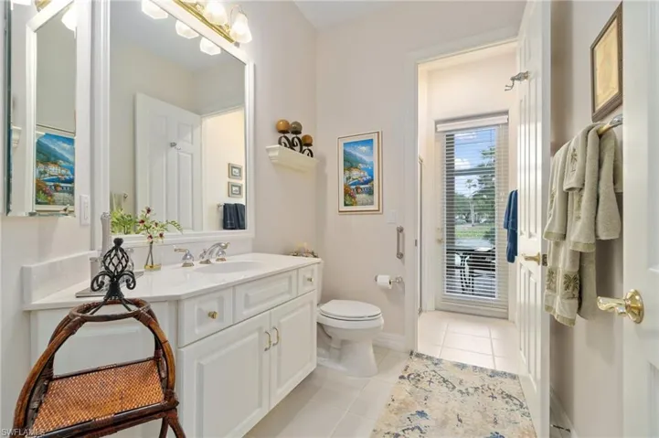 Bathroom with baseboards, toilet, tile patterned floors, and vanity