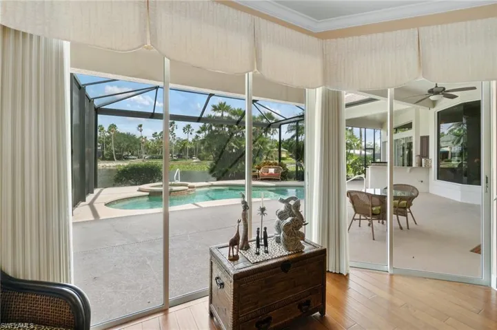 View of swimming pool featuring a ceiling fan and a pool with connected hot tub