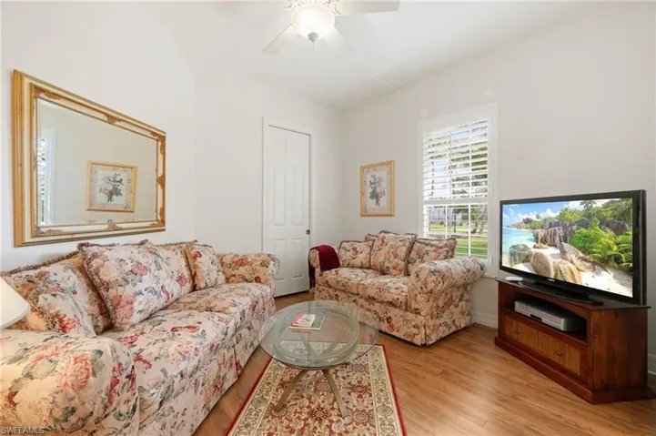 Living room with a ceiling fan and light wood finished floors