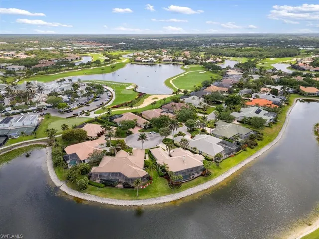 Bird's eye view featuring golf course view, a water view, and a residential view