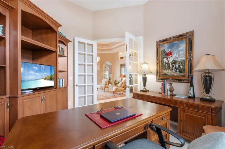 Office with arched walkways and french doors