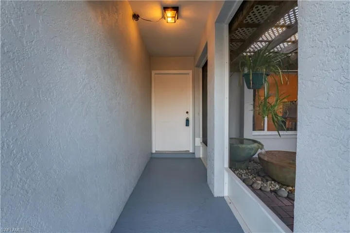 Property entrance featuring a balcony