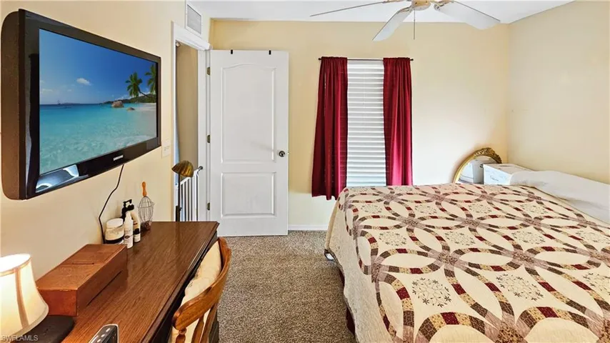 Bedroom featuring a ceiling fan, visible vents, and carpet floors