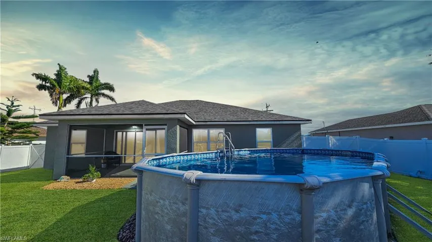 View of pool with a yard, a fenced in pool, a fenced backyard, and a sunroom