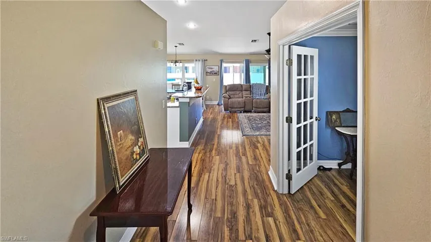 Foyer with baseboards and dark wood-style flooring