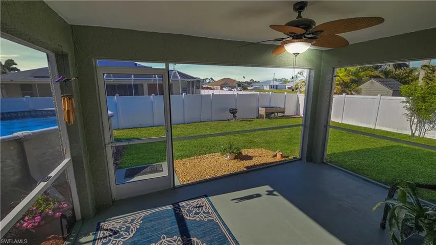 Sunroom featuring a ceiling fan