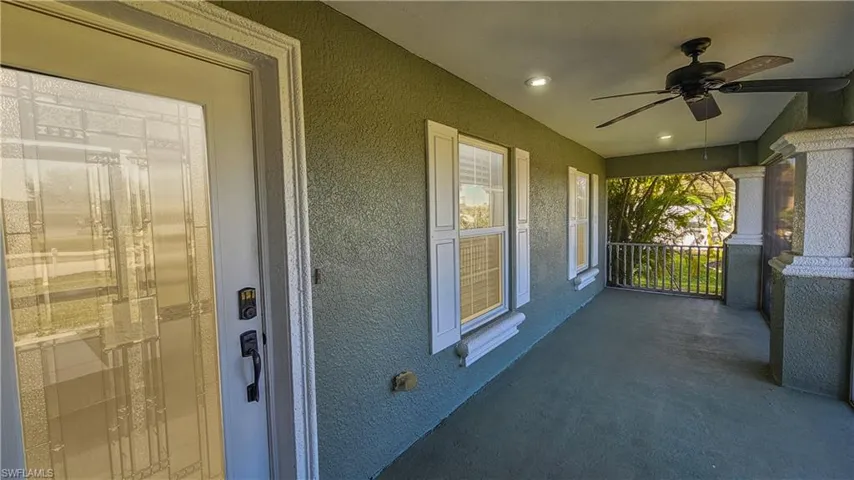 Property entrance featuring stucco siding and ceiling fan
