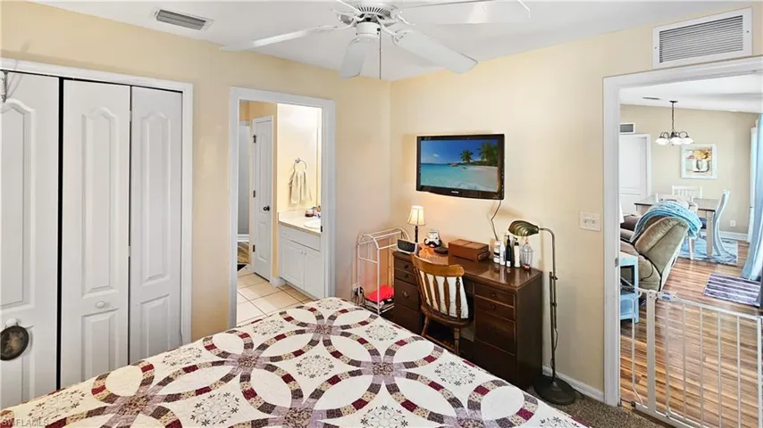 Bedroom with visible vents, baseboards, and a closet