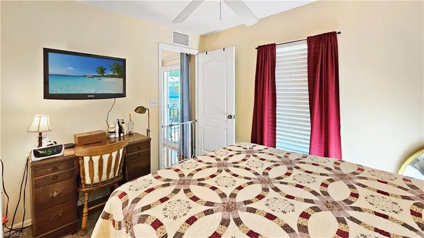 Bedroom with visible vents and a ceiling fan