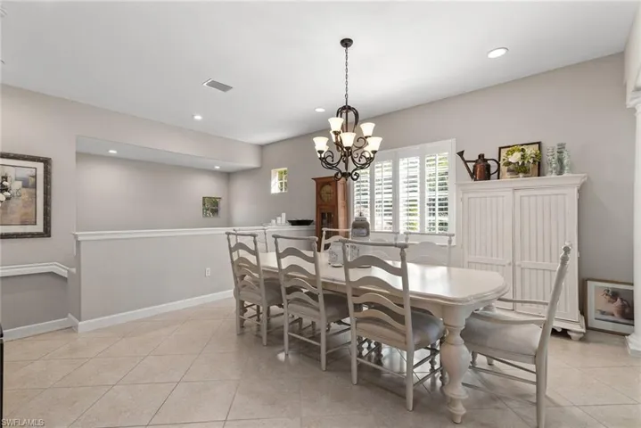 Dining area featuring recessed lighting, a chandelier, and light tile patterned floors