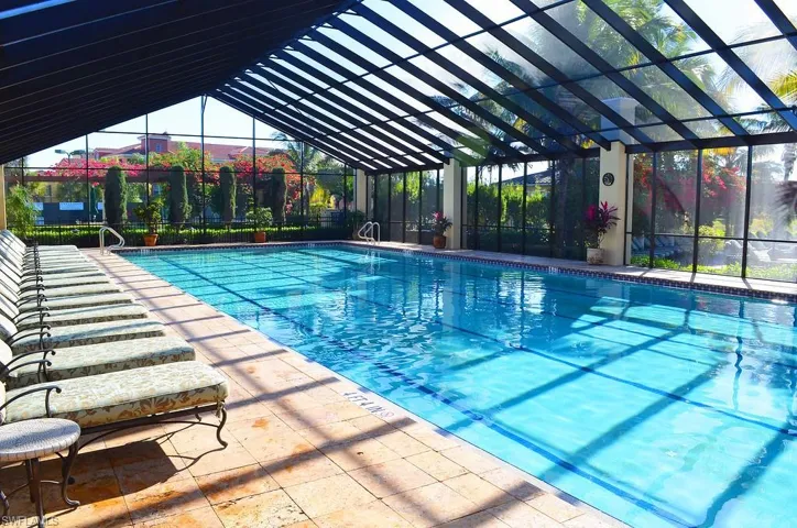 Community pool with glass enclosure and a patio