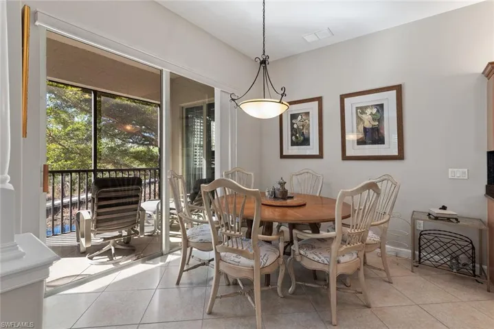 Dining space with light tile patterned floors