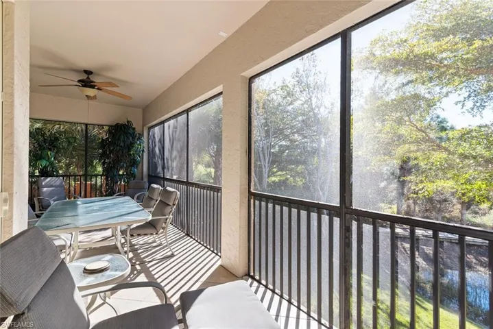 Sunroom / solarium with ceiling fan, outdoor dining area, and a balcony