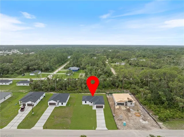 Aerial view of residential area with a heavily wooded area