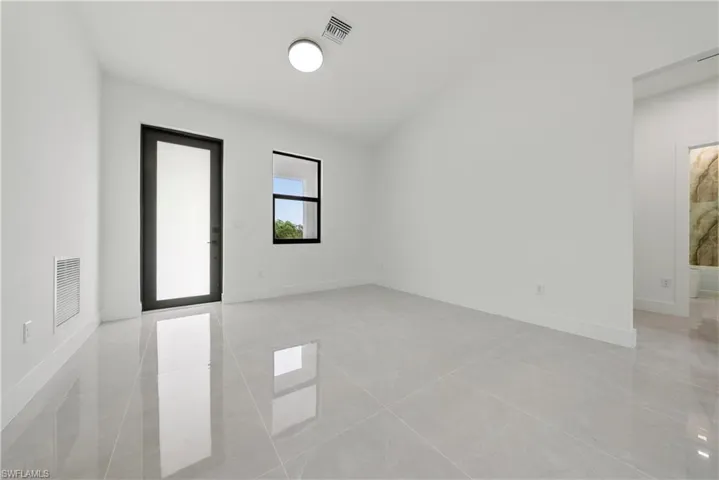 Spare room featuring baseboards and light tile patterned floors
