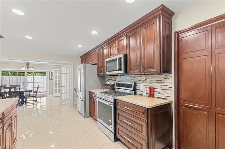 Kitchen View to Formal Dining area and Patio