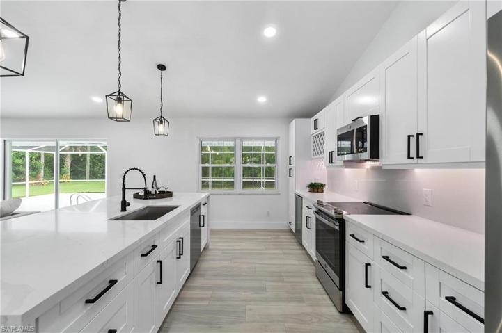 Kitchen, featuring new white shaker-cabinetry, stainless steel appliances and quartz countertops