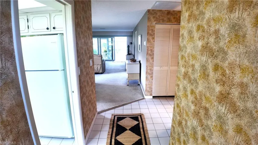 Single-story residence featuring a blue entry door, complementary window shutters, and a well-maintained front lawn