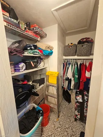 Walk in closet with light tile patterned flooring