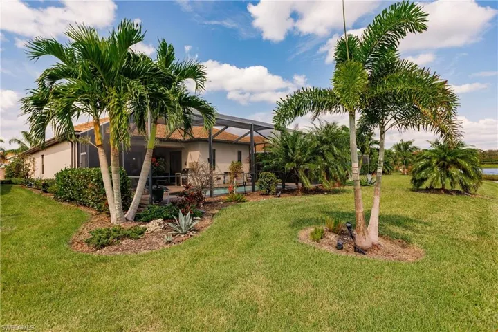 View of nicely landscaped yard with a patio area and a lanai