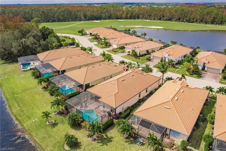 Birds eye view of property with a water view