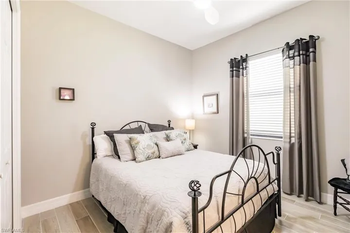 Bedroom featuring light tile flooring and ceiling fan