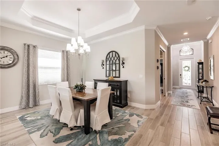 Dining area featuring crown molding, and a raised ceiling