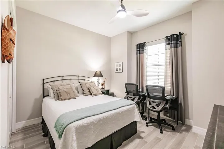 Guest Bedroom featuring ceiling fan and light tile flooring